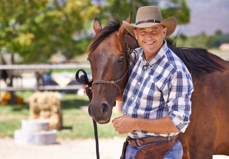 Rick Smith standing with a horse.